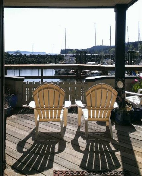 Two deck chairs looking out over the Ganges marina